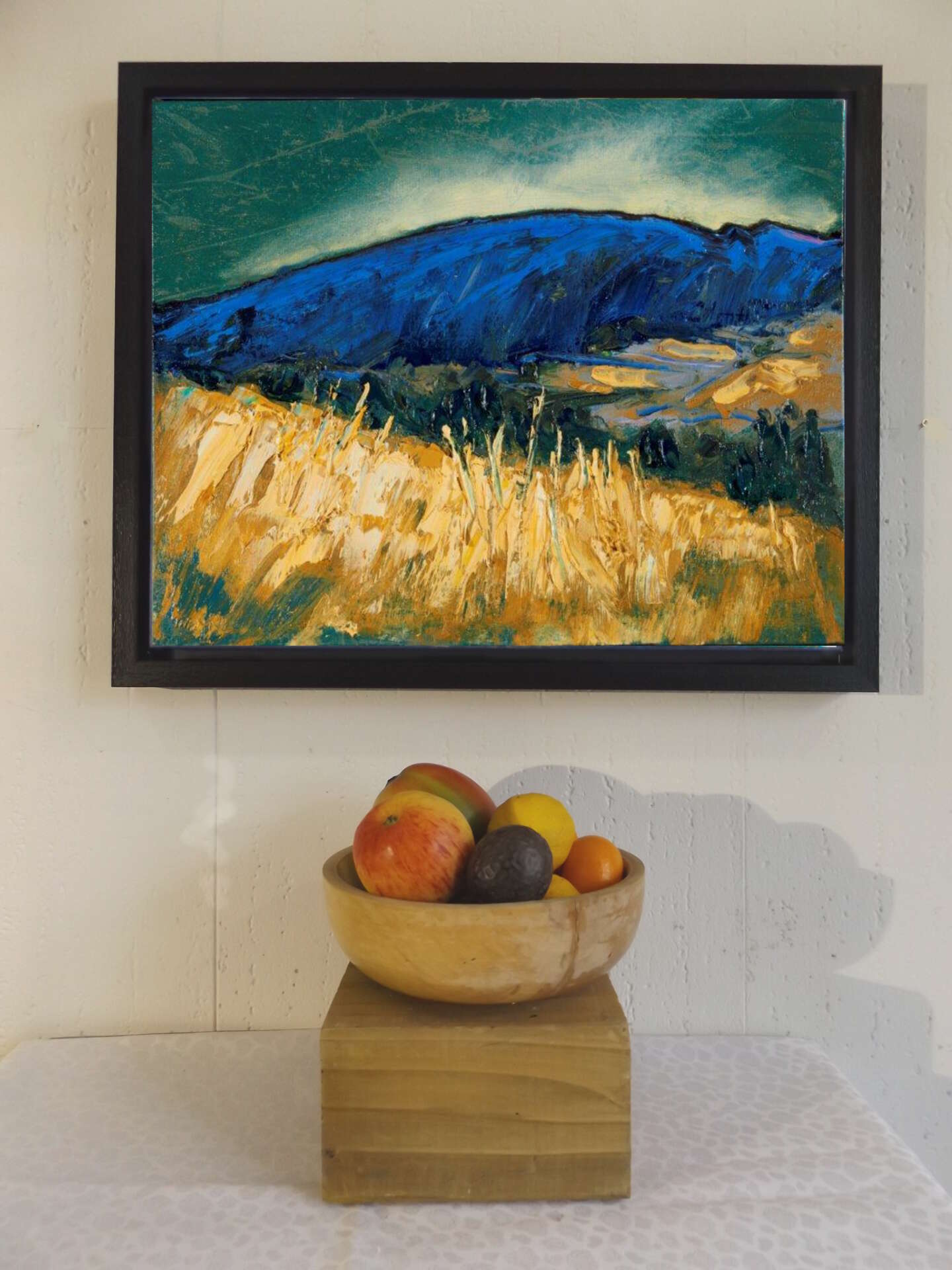 Sleeping Giant canvas print hung with apples in the foreground for scale.