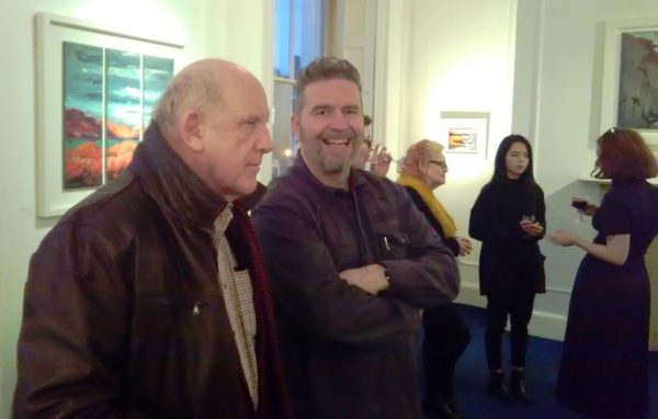 Rod explains his method for Seeing Red to a guest at his exhibition launch at the Origin Gallery, Dublin.