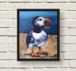 image of preaching puffin painting in a black frame on a white wall